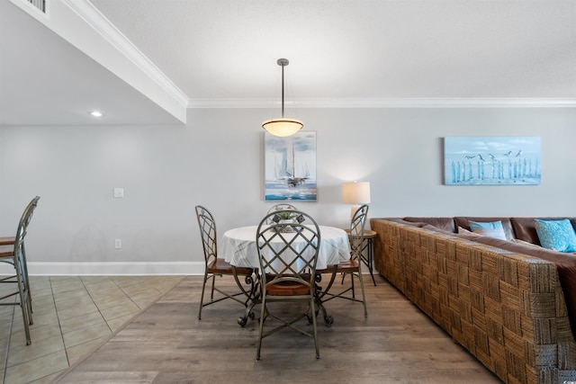 dining area featuring crown molding and tile patterned floors