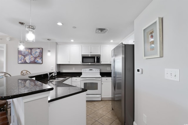 kitchen with pendant lighting, sink, a breakfast bar, appliances with stainless steel finishes, and kitchen peninsula