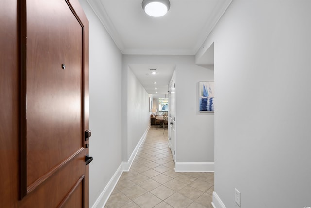 corridor with crown molding and light tile patterned flooring