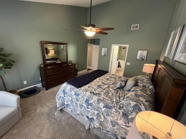 carpeted bedroom featuring ceiling fan and high vaulted ceiling