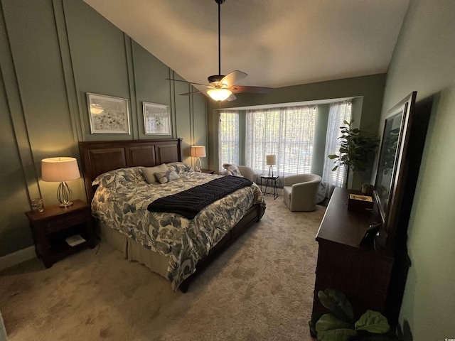 bedroom with vaulted ceiling, light colored carpet, and ceiling fan