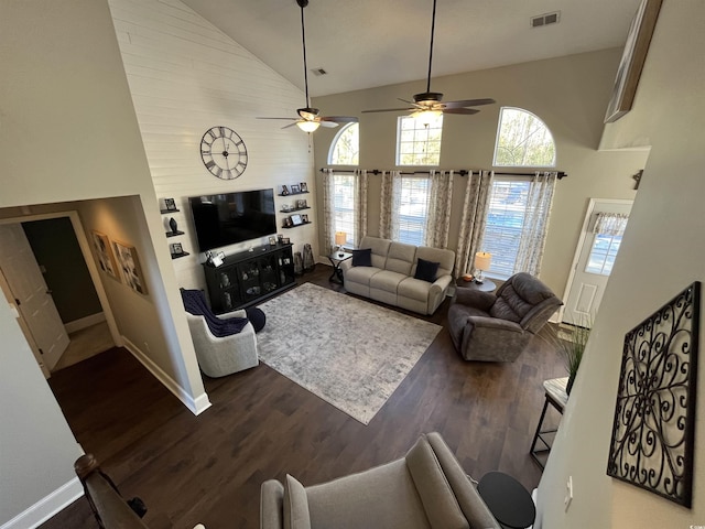 living room with high vaulted ceiling and dark hardwood / wood-style flooring