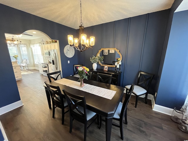 dining area featuring an inviting chandelier and dark hardwood / wood-style flooring