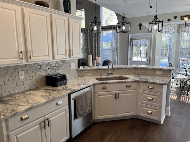 kitchen with white cabinetry, stainless steel dishwasher, kitchen peninsula, and sink