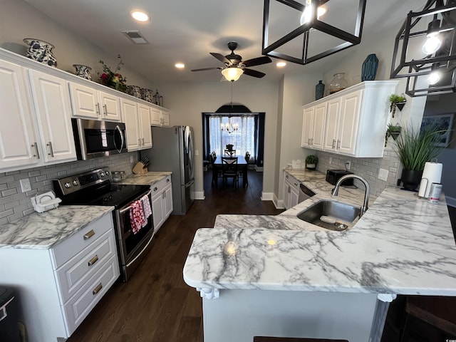 kitchen featuring light stone countertops, appliances with stainless steel finishes, sink, and white cabinets