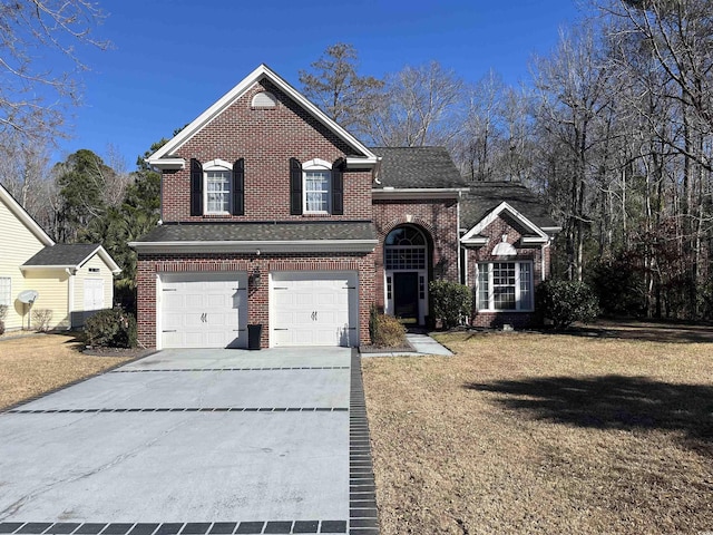 view of front property with a garage and a front yard