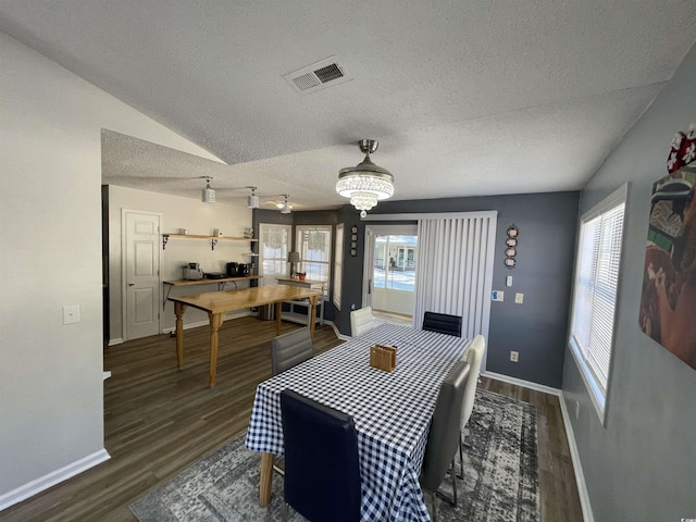 dining space featuring an inviting chandelier, dark hardwood / wood-style floors, and a textured ceiling