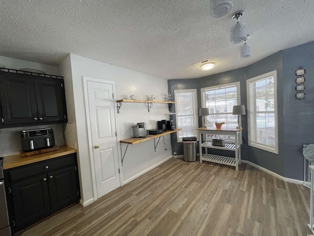 kitchen with light hardwood / wood-style flooring and a textured ceiling