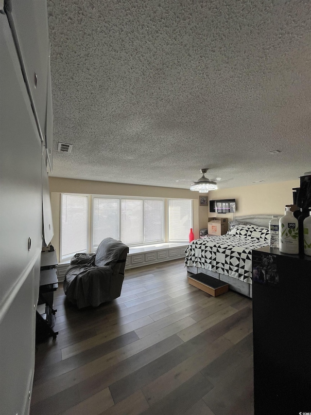 bedroom with wood-type flooring and a textured ceiling