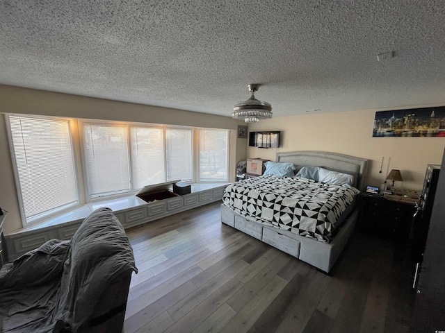 bedroom featuring wood-type flooring and a textured ceiling