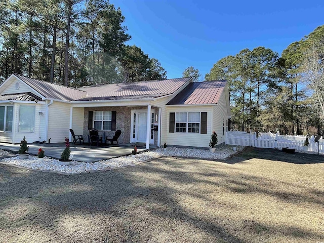 single story home with a front yard and a patio area