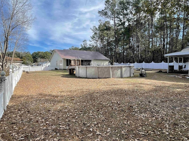 view of yard with a fenced in pool