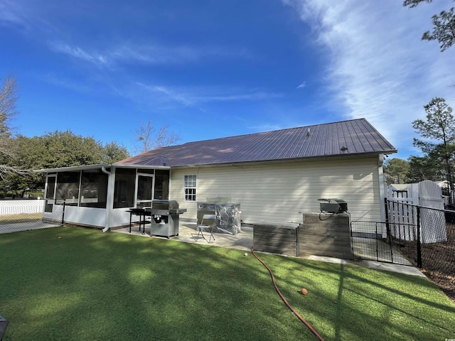 back of property with a patio, a yard, and a sunroom