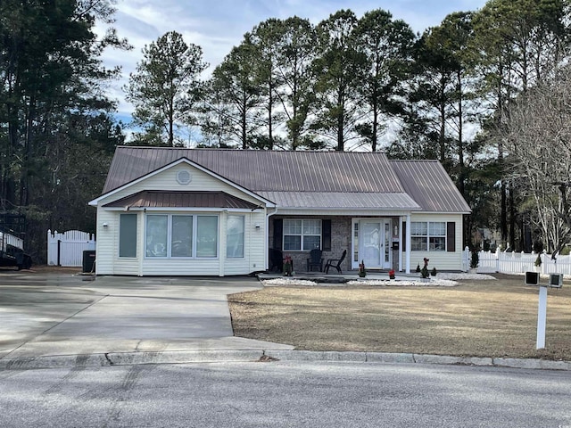 ranch-style home featuring cooling unit and a front lawn