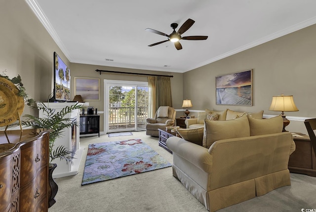 living room with crown molding, light colored carpet, and ceiling fan