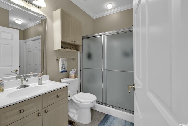 bathroom featuring toilet, vanity, walk in shower, crown molding, and tile patterned floors