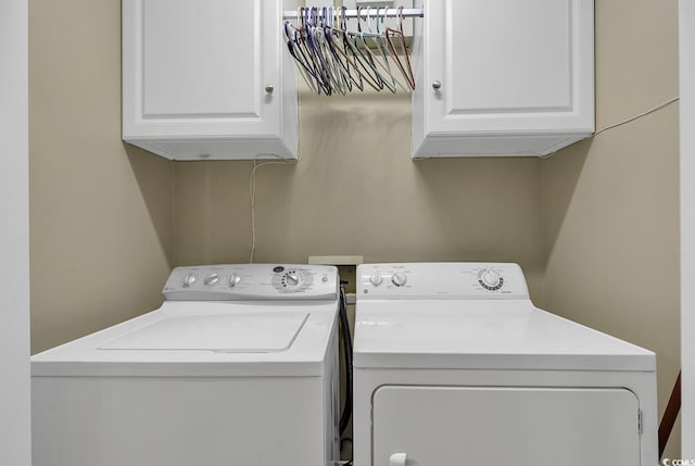 laundry area with cabinets and washing machine and clothes dryer