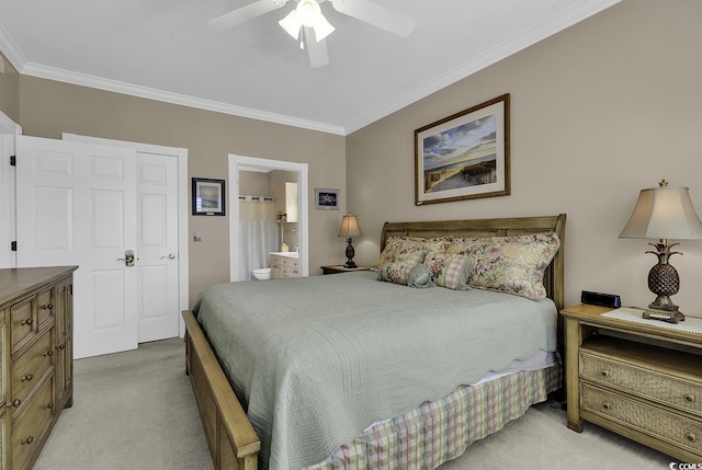 carpeted bedroom with crown molding, ensuite bath, and ceiling fan