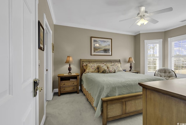 bedroom with crown molding, light colored carpet, and ceiling fan