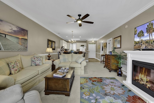 living room with ceiling fan with notable chandelier, ornamental molding, and light colored carpet