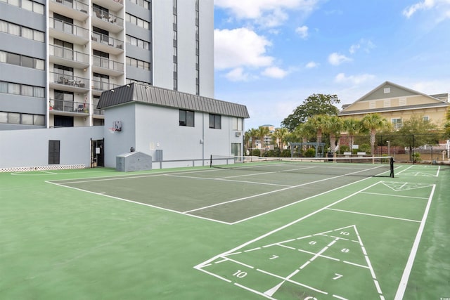 view of property's community with tennis court