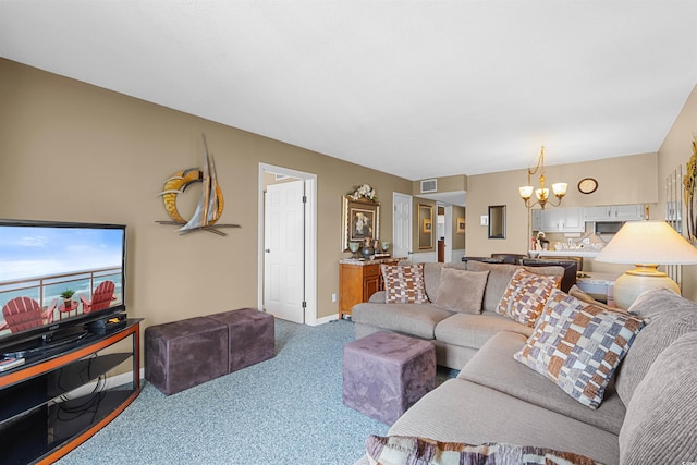 carpeted living room featuring a notable chandelier