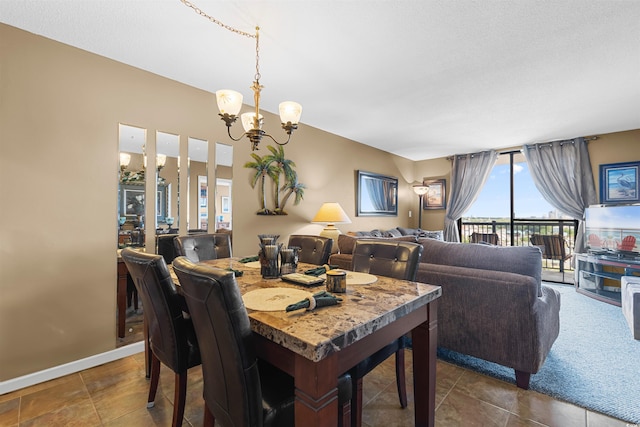 tiled dining room featuring an inviting chandelier