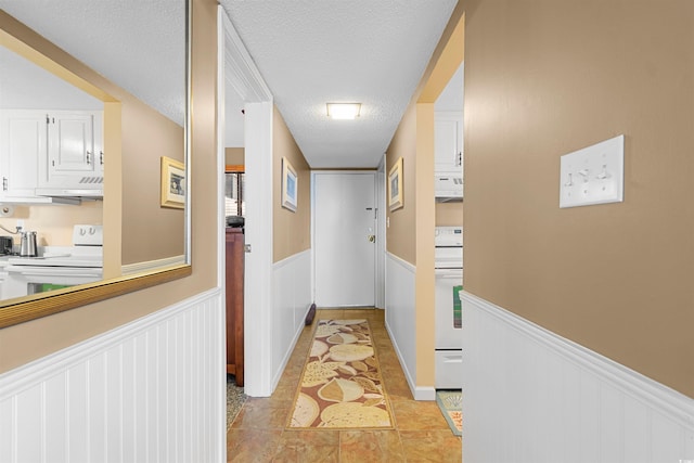 hallway with a textured ceiling