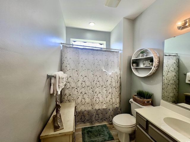 full bathroom featuring shower / bath combination with curtain, vanity, toilet, and hardwood / wood-style floors