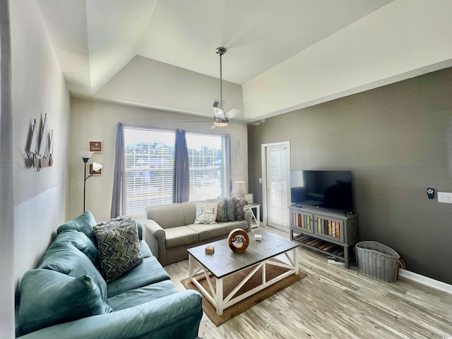 living room with hardwood / wood-style flooring, ceiling fan, and lofted ceiling