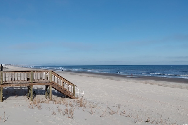 view of home's community with a beach view and a water view