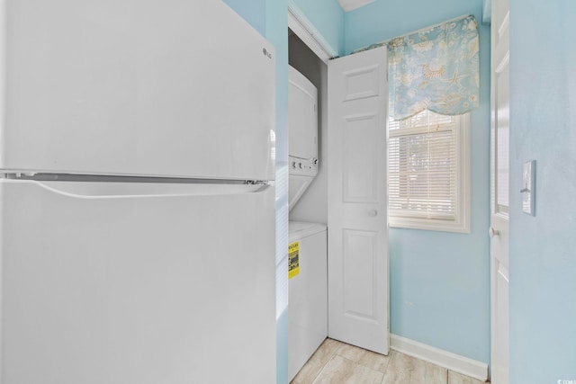 laundry area featuring stacked washing maching and dryer