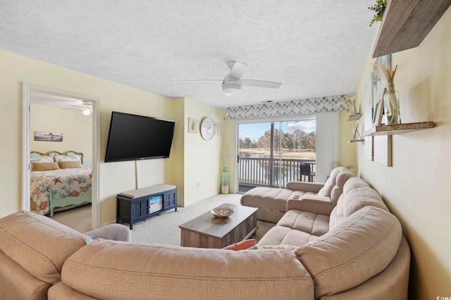 living room featuring ceiling fan, light colored carpet, and a textured ceiling