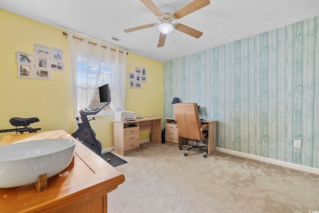 carpeted home office featuring sink, a textured ceiling, and ceiling fan