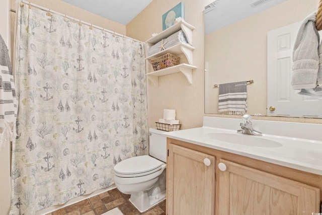 bathroom featuring a shower with curtain, vanity, and toilet