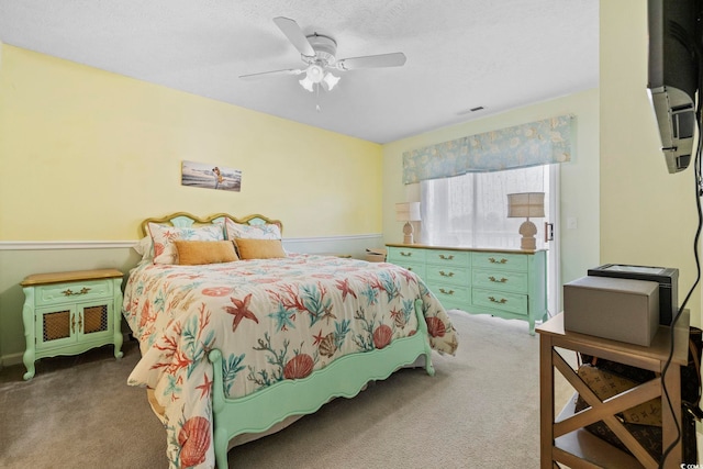 carpeted bedroom with a textured ceiling and ceiling fan