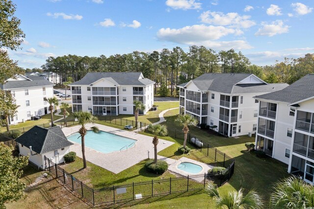 view of swimming pool featuring a yard and a patio area