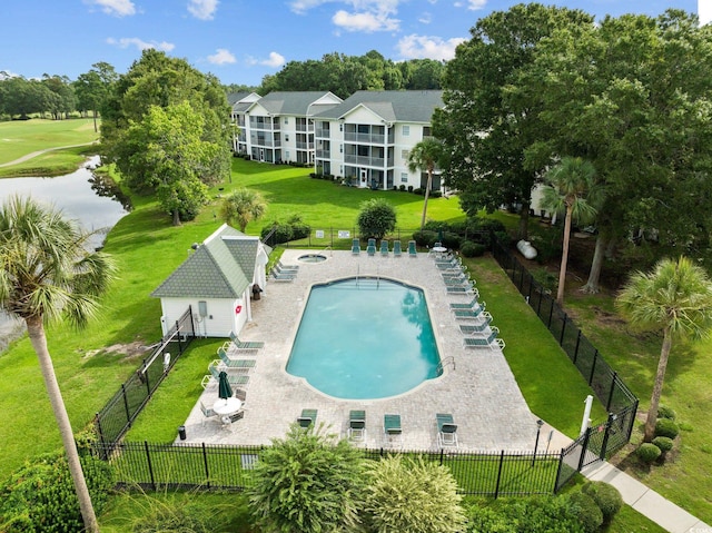 view of swimming pool with an outbuilding, a yard, and a patio