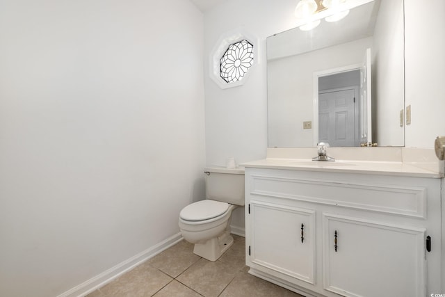 bathroom featuring vanity, tile patterned floors, and toilet