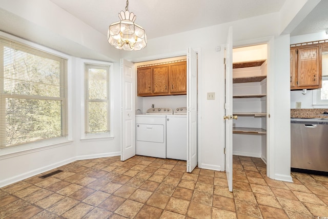 kitchen with dishwasher, separate washer and dryer, hanging light fixtures, a textured ceiling, and an inviting chandelier