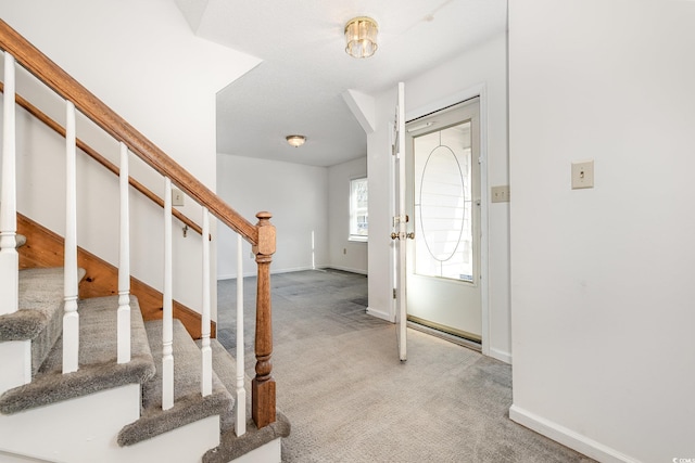 view of carpeted foyer entrance