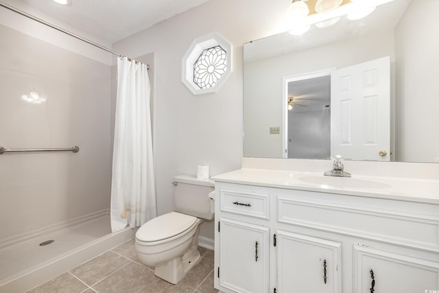 bathroom featuring vanity, curtained shower, tile patterned floors, and toilet