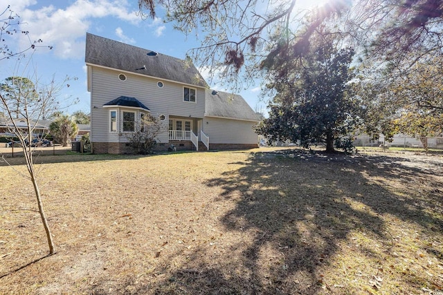 back of property featuring a lawn