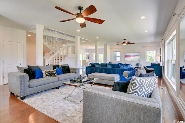 living room with a ceiling fan, stairway, wood finished floors, and recessed lighting