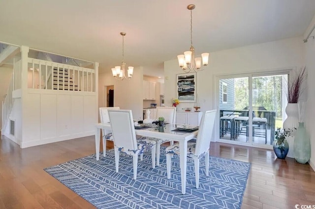 dining room featuring visible vents, a chandelier, and wood finished floors