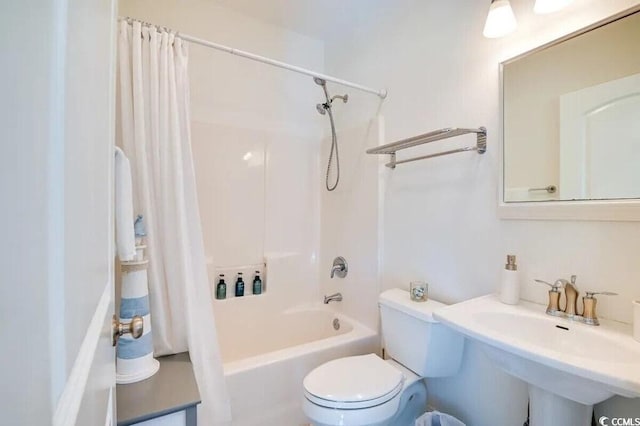 bathroom with a sink, shower / bathtub combination with curtain, and toilet