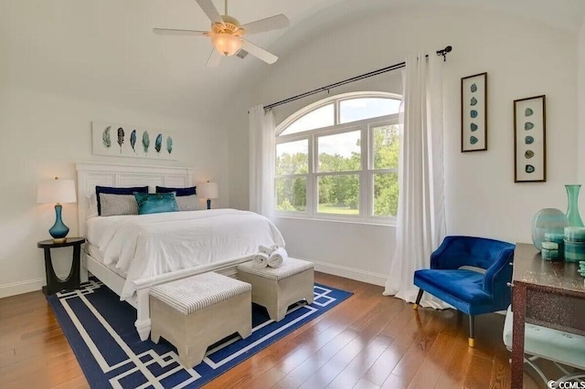 bedroom with lofted ceiling, baseboards, and wood finished floors