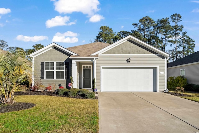 view of front of property with a garage and a front lawn