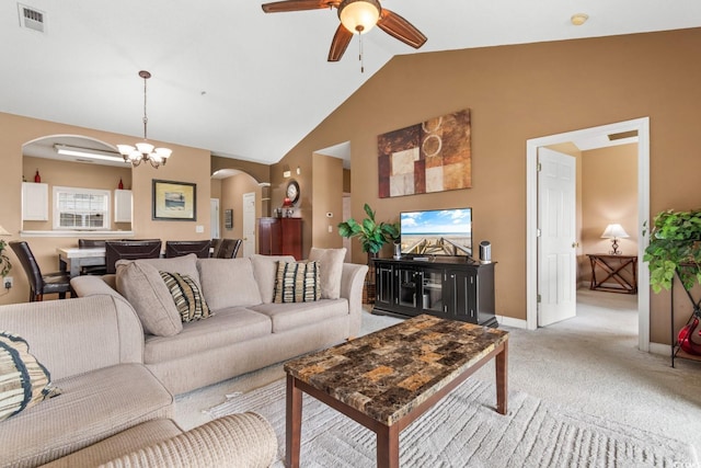 living room featuring lofted ceiling, ceiling fan with notable chandelier, and light colored carpet