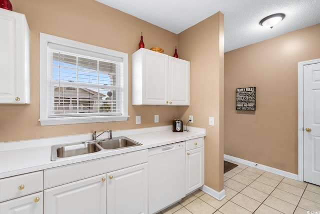 kitchen with white dishwasher, sink, and white cabinetry